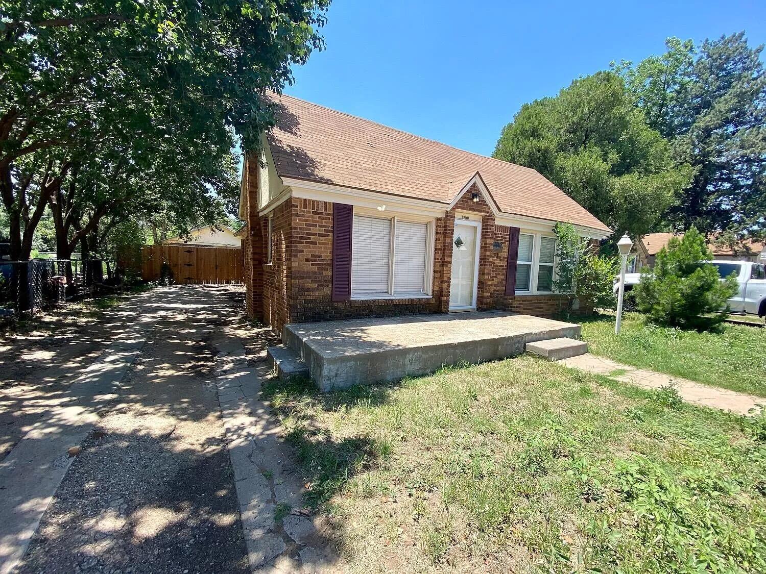 2109 22nd Street, Unit FRONT Lubbock, TX 79411 - Photo 2 of 16 a front view of a house with a yard