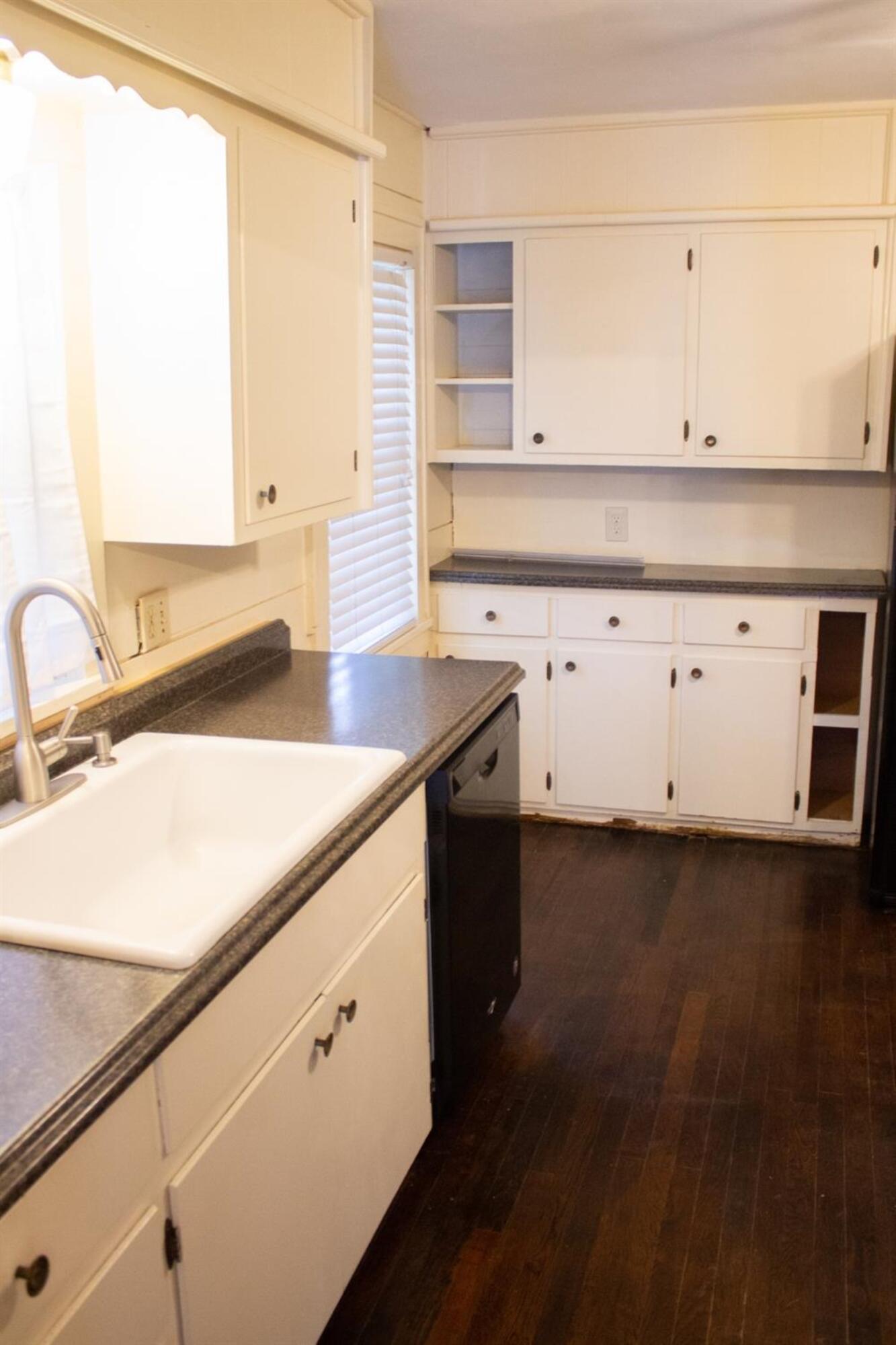2109 22nd Street, Unit FRONT Lubbock, TX 79411 - Photo 6 of 16 a kitchen with a sink cabinets and wooden floor