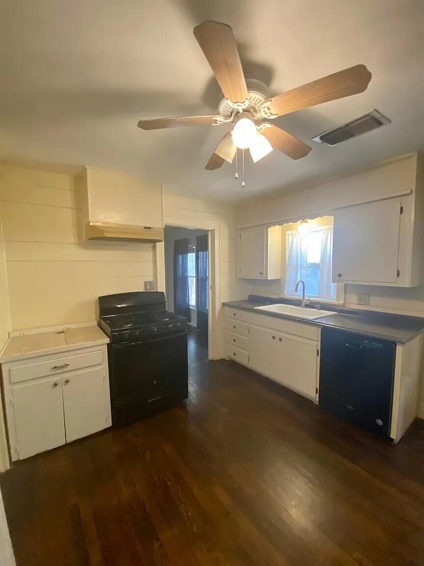 2109 22nd Street, Unit FRONT Lubbock, TX 79411 - Photo 8 of 16 a kitchen with granite countertop a refrigerator and a stove top oven