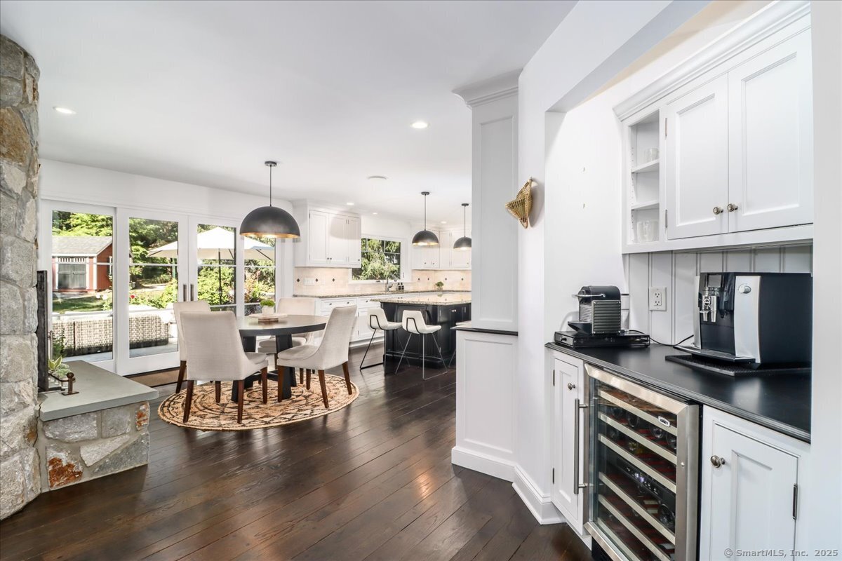 81 Graenest Ridge Road Wilton, CT 06897 - Photo 11 of 39 a open kitchen with stainless steel appliances granite countertop a stove and white cabinets with wooden floor