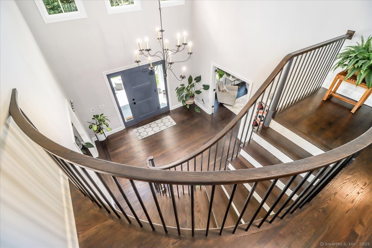 81 Graenest Ridge Road Wilton, CT 06897 - Photo 15 of 39 a view of a livingroom with furniture wooden floor and staircase
