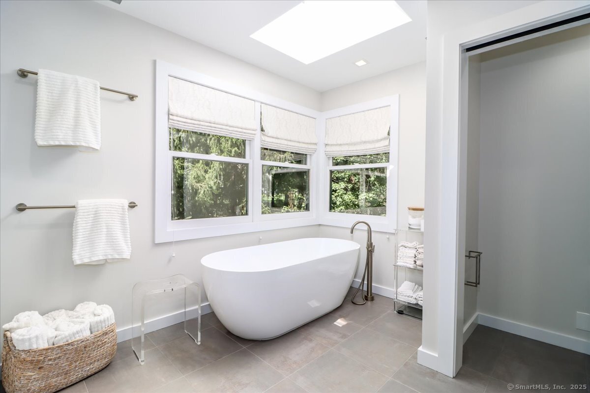 81 Graenest Ridge Road Wilton, CT 06897 - Photo 17 of 39 a spacious bathroom with a tub and window