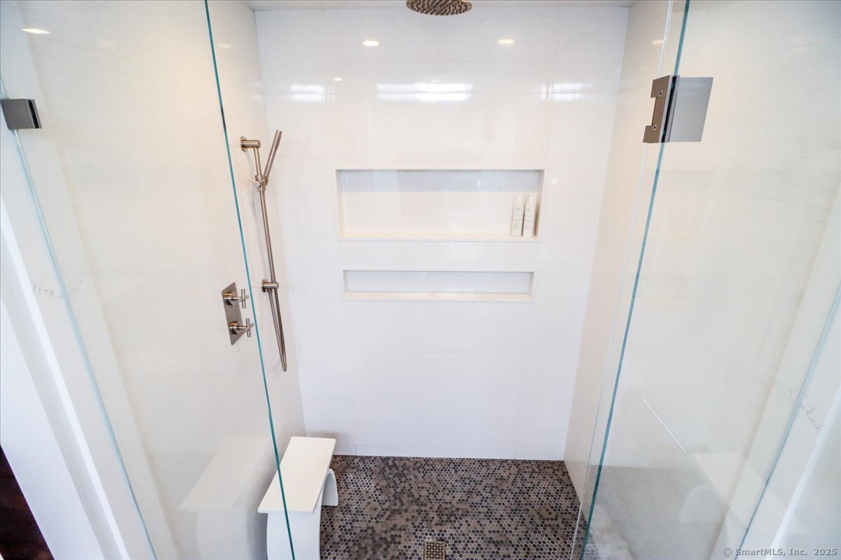 81 Graenest Ridge Road Wilton, CT 06897 - Photo 18 of 39 walk in closet with wooden floor and window