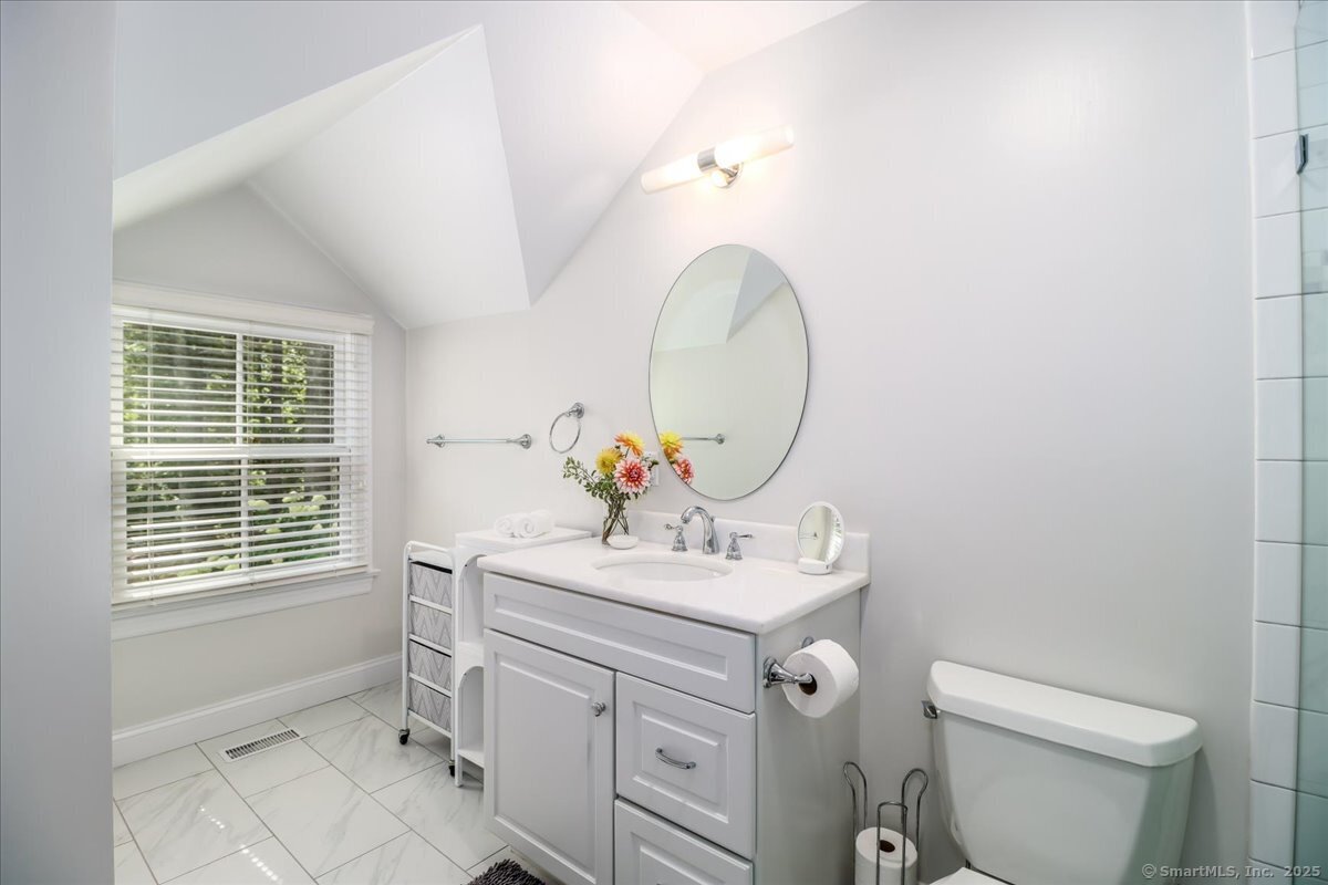 81 Graenest Ridge Road Wilton, CT 06897 - Photo 21 of 39 a bathroom with a sink toilet and a mirror