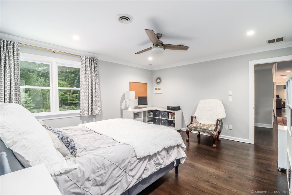 81 Graenest Ridge Road Wilton, CT 06897 - Photo 22 of 39 a spacious bedroom with a bed and a large window