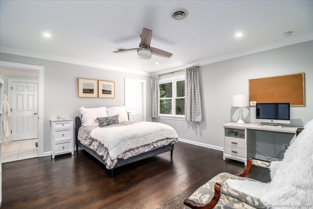 81 Graenest Ridge Road Wilton, CT 06897 - Photo 23 of 39 a bedroom with a bed and a desk