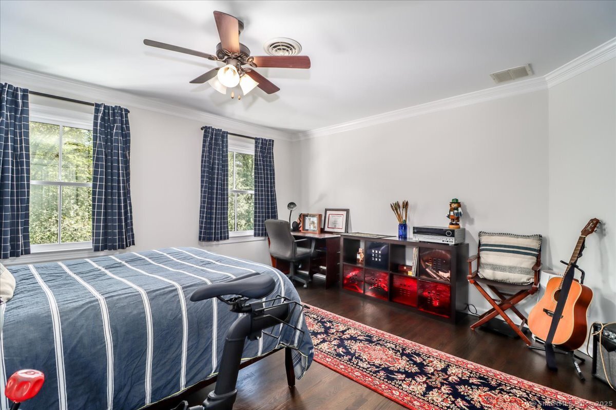 81 Graenest Ridge Road Wilton, CT 06897 - Photo 25 of 39 a bed room with two beds and a chandelier