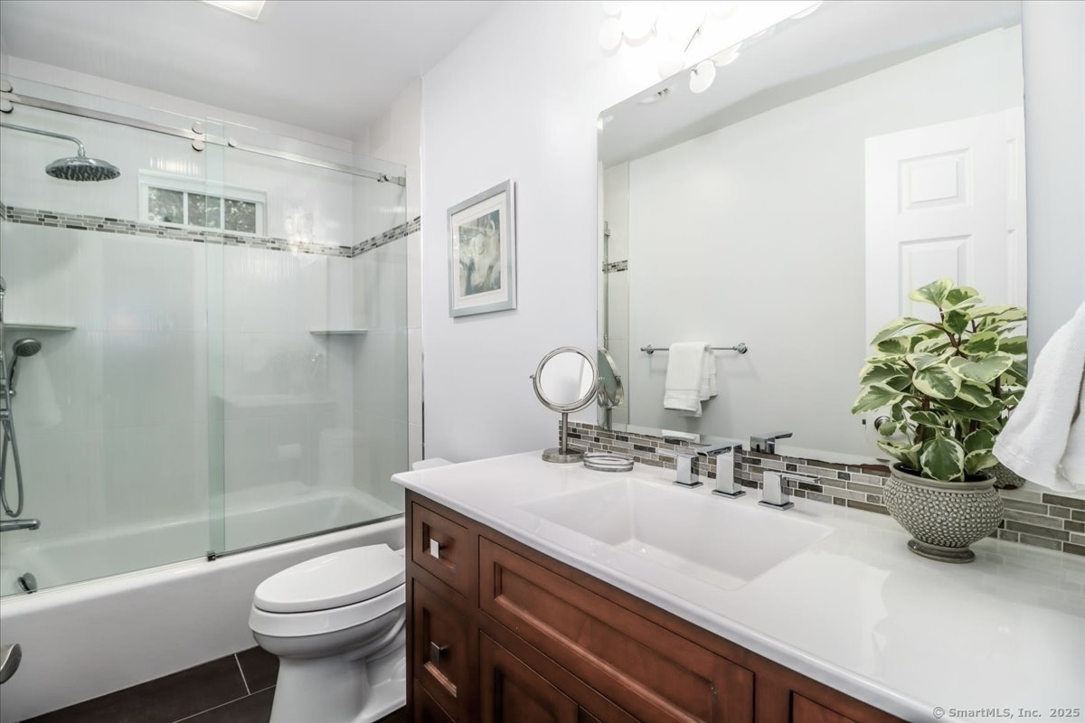 81 Graenest Ridge Road Wilton, CT 06897 - Photo 26 of 39 a bathroom with a sink a toilet and shower