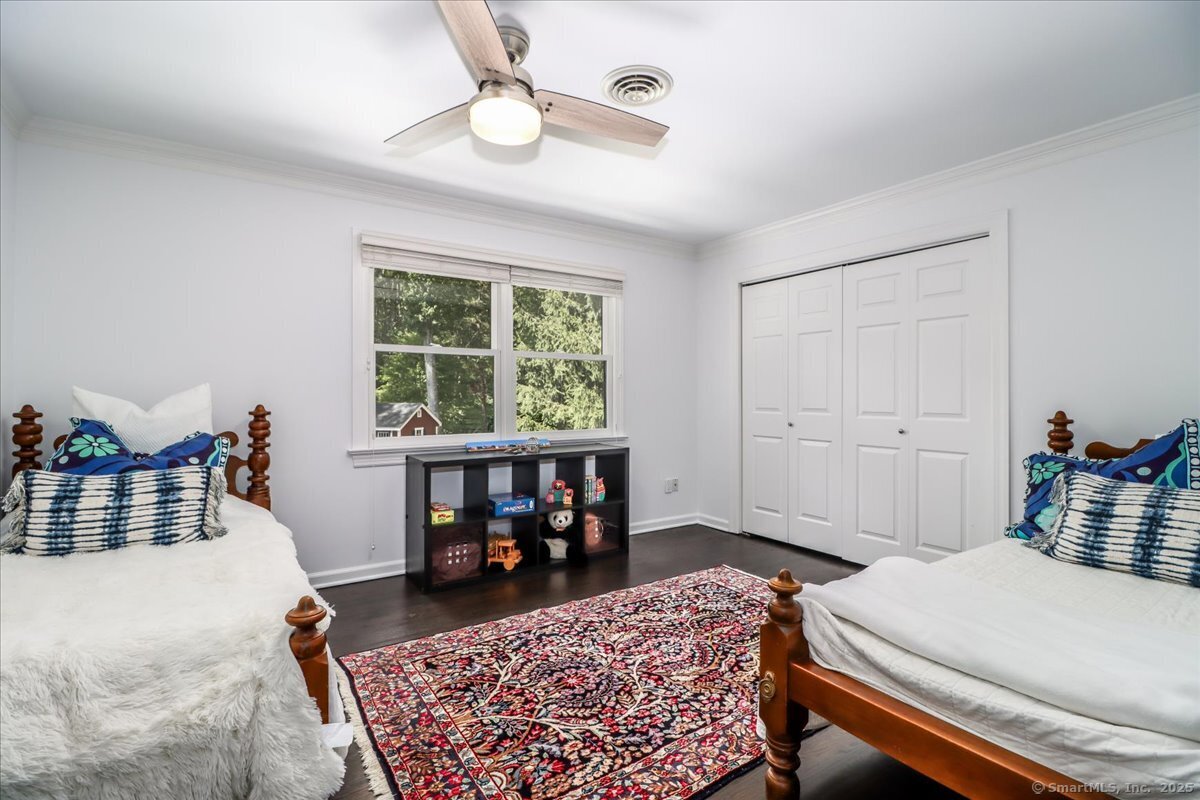 81 Graenest Ridge Road Wilton, CT 06897 - Photo 27 of 39 a bedroom with a bed and a table in it