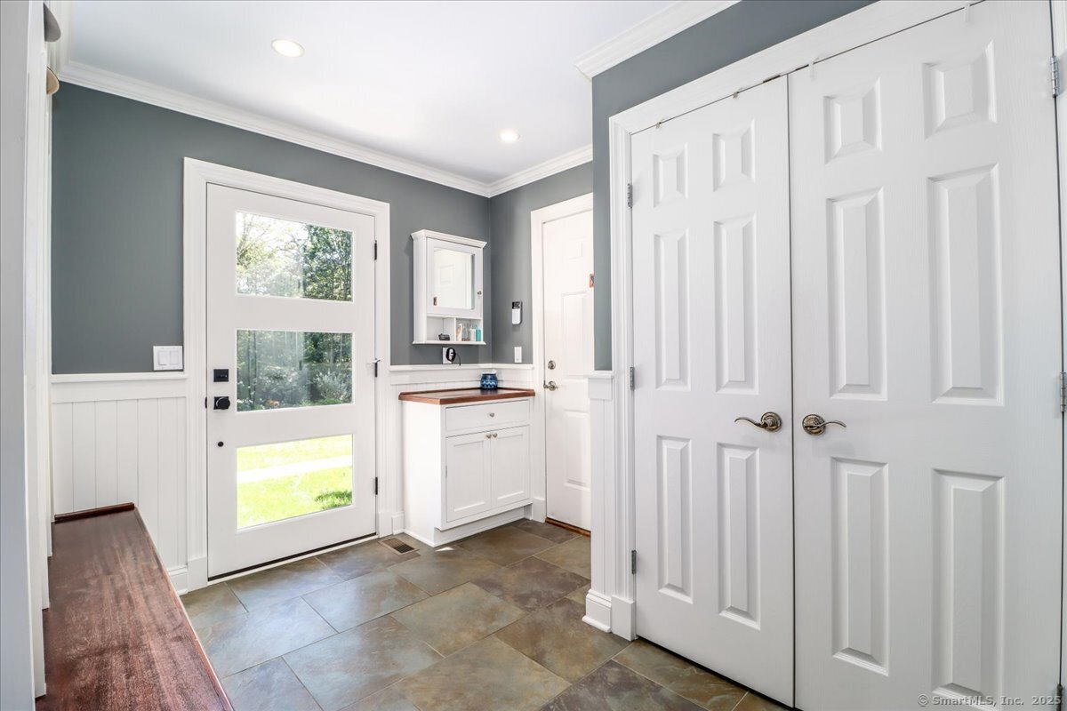 81 Graenest Ridge Road Wilton, CT 06897 - Photo 29 of 39 a view of a kitchen with white cabinets and wooden floor