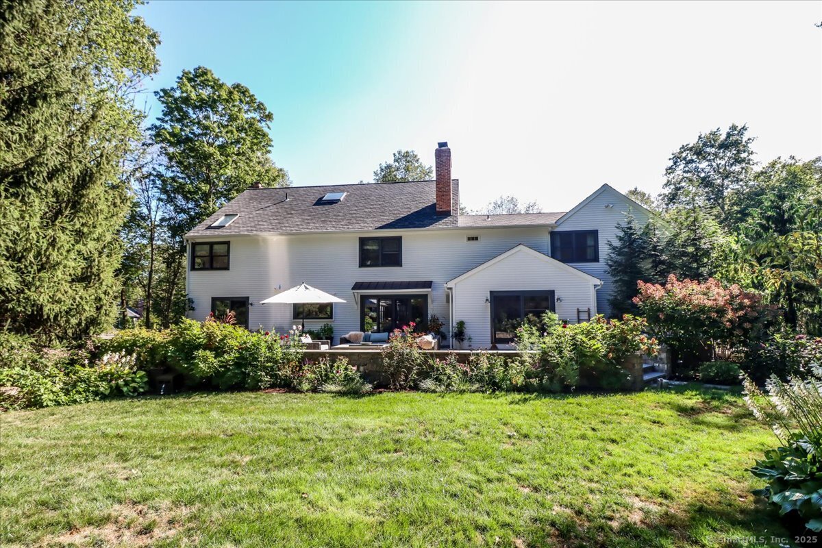 81 Graenest Ridge Road Wilton, CT 06897 - Photo 39 of 39 a front view of house with yard and trees in the background