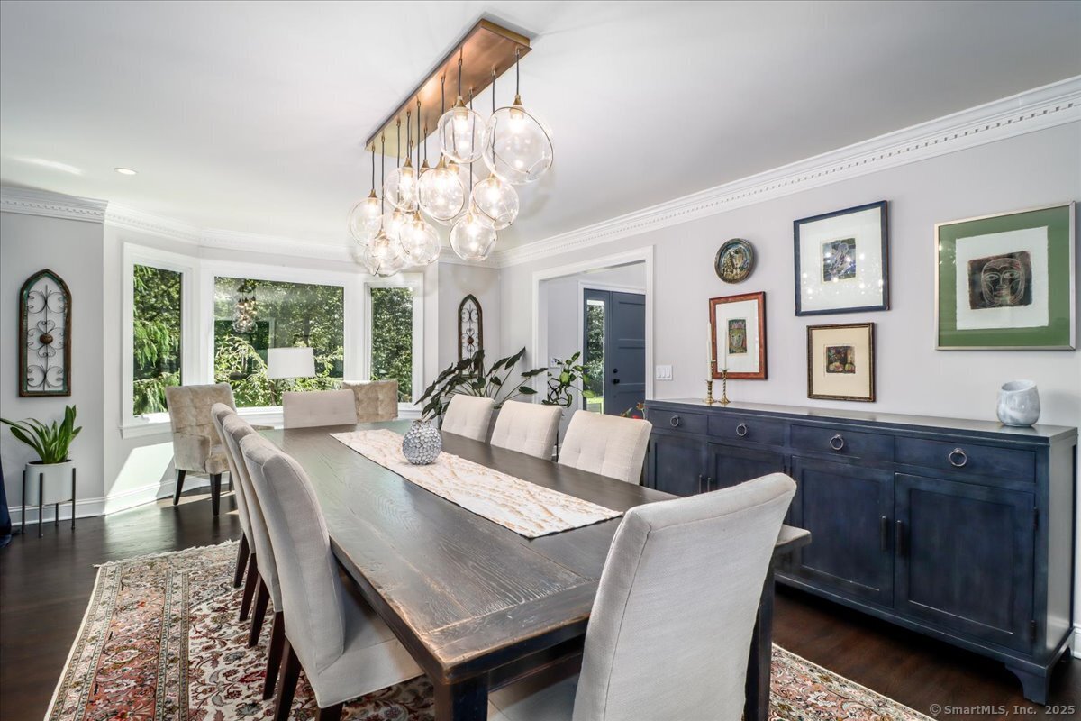 81 Graenest Ridge Road Wilton, CT 06897 - Photo 4 of 39 a view of a dining room with furniture a chandelier and wooden floor