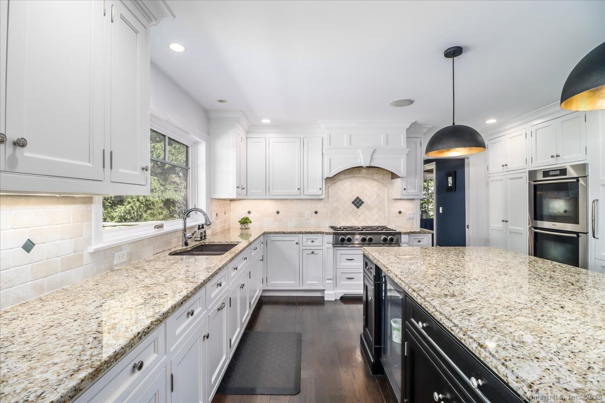81 Graenest Ridge Road Wilton, CT 06897 - Photo 8 of 39 a large kitchen with granite countertop a stove oven and a sink with granite countertops