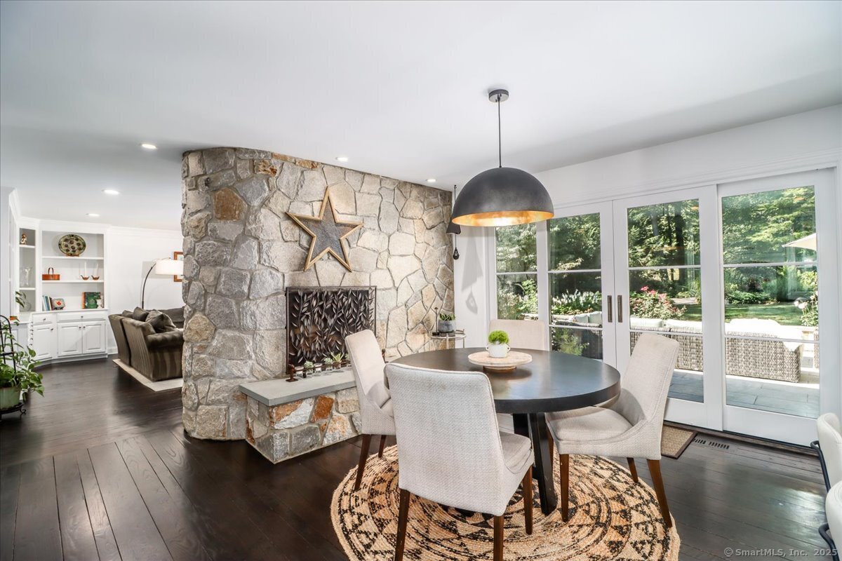 81 Graenest Ridge Road Wilton, CT 06897 - Photo 10 of 39 a dining room with furniture a chandelier and wooden floor