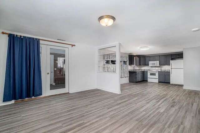 a view of a kitchen with wooden floor and a sink