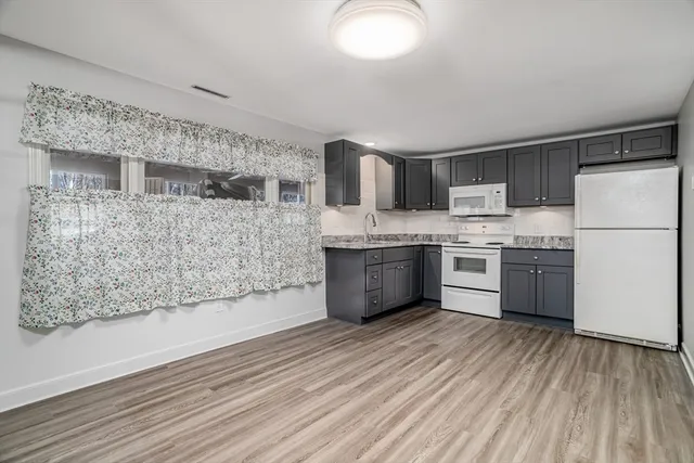 a kitchen with stainless steel appliances a refrigerator sink and cabinets