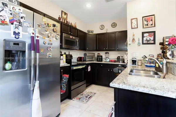 a kitchen with refrigerator and cabinets