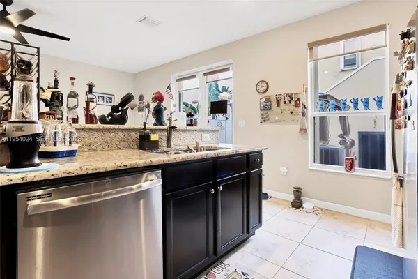 a kitchen with stainless steel appliances granite countertop a sink and cabinets