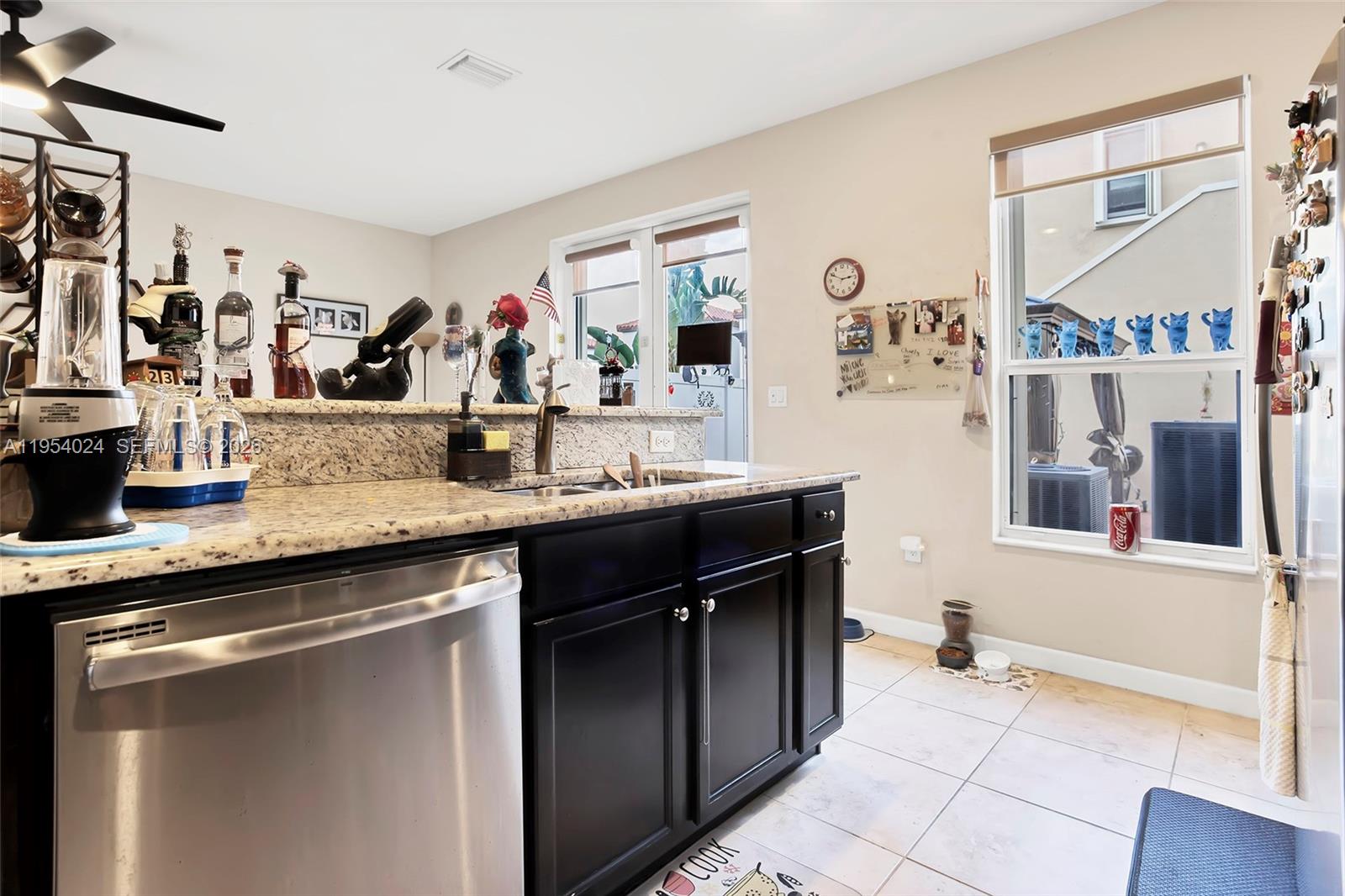 17149 Southwest 94th Street Miami, FL 33196 - Photo 12 of 36 a kitchen with stainless steel appliances granite countertop a sink and cabinets