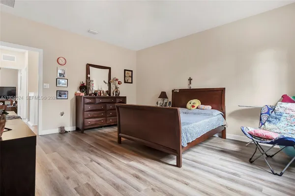 a bedroom with a bed and dresser