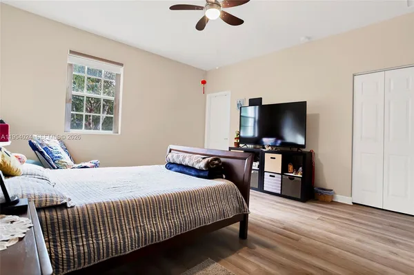 a bedroom with a bed and a flat screen tv