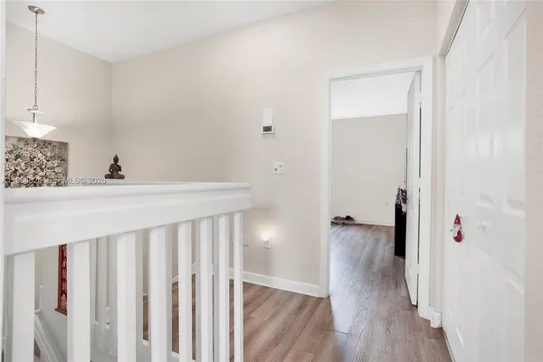 a view of a hallway with wooden floor