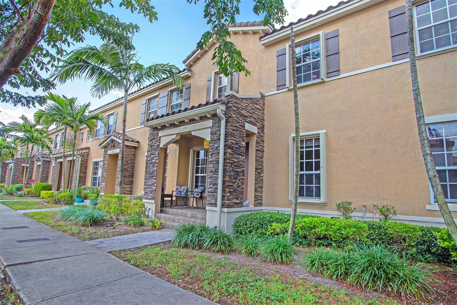 17149 Southwest 94th Street Miami, FL 33196 - Photo 2 of 36 front view of a house with a garden