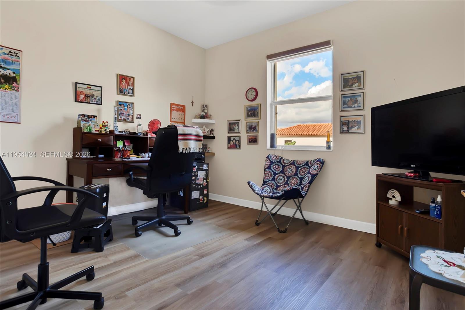 17149 Southwest 94th Street Miami, FL 33196 - Photo 22 of 36 a living room with furniture and a flat screen tv