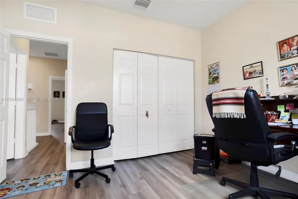 a view of a workspace with furniture and wooden floor