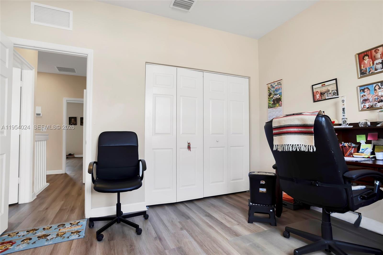 17149 Southwest 94th Street Miami, FL 33196 - Photo 23 of 36 a view of a workspace with furniture and wooden floor