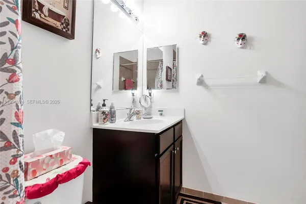 a bathroom with a sink vanity and a mirror