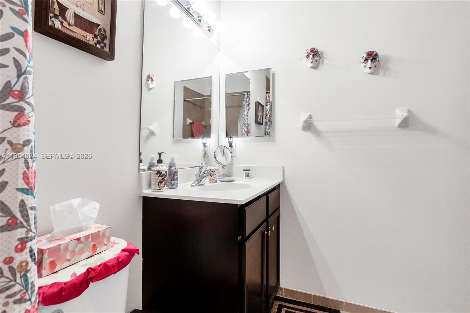 17149 Southwest 94th Street Miami, FL 33196 - Photo 26 of 36 a bathroom with a sink vanity and a mirror