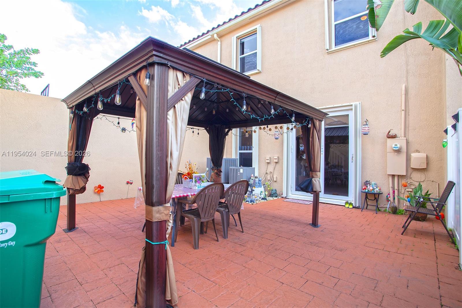 17149 Southwest 94th Street Miami, FL 33196 - Photo 30 of 36 a view of a house with backyard and sitting area