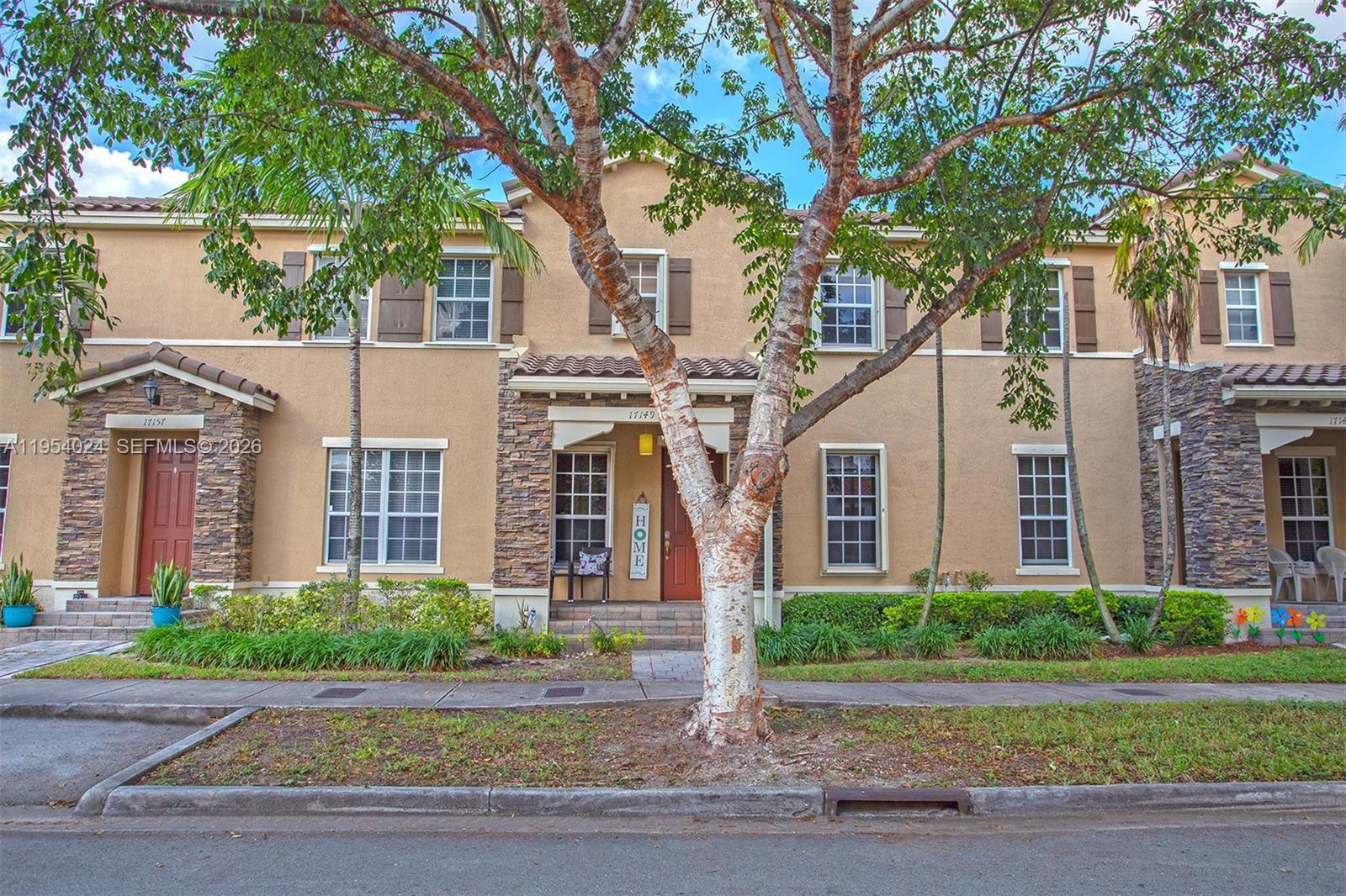 17149 Southwest 94th Street Miami, FL 33196 - Photo 3 of 36 front view of a house with a yard