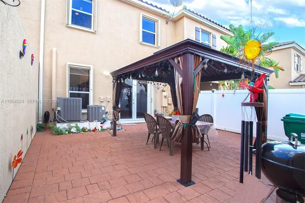 a view of a house with backyard and sitting area