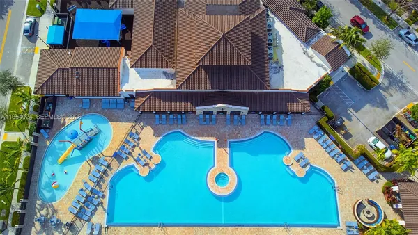 an aerial view of a house with garden space and outdoor seating
