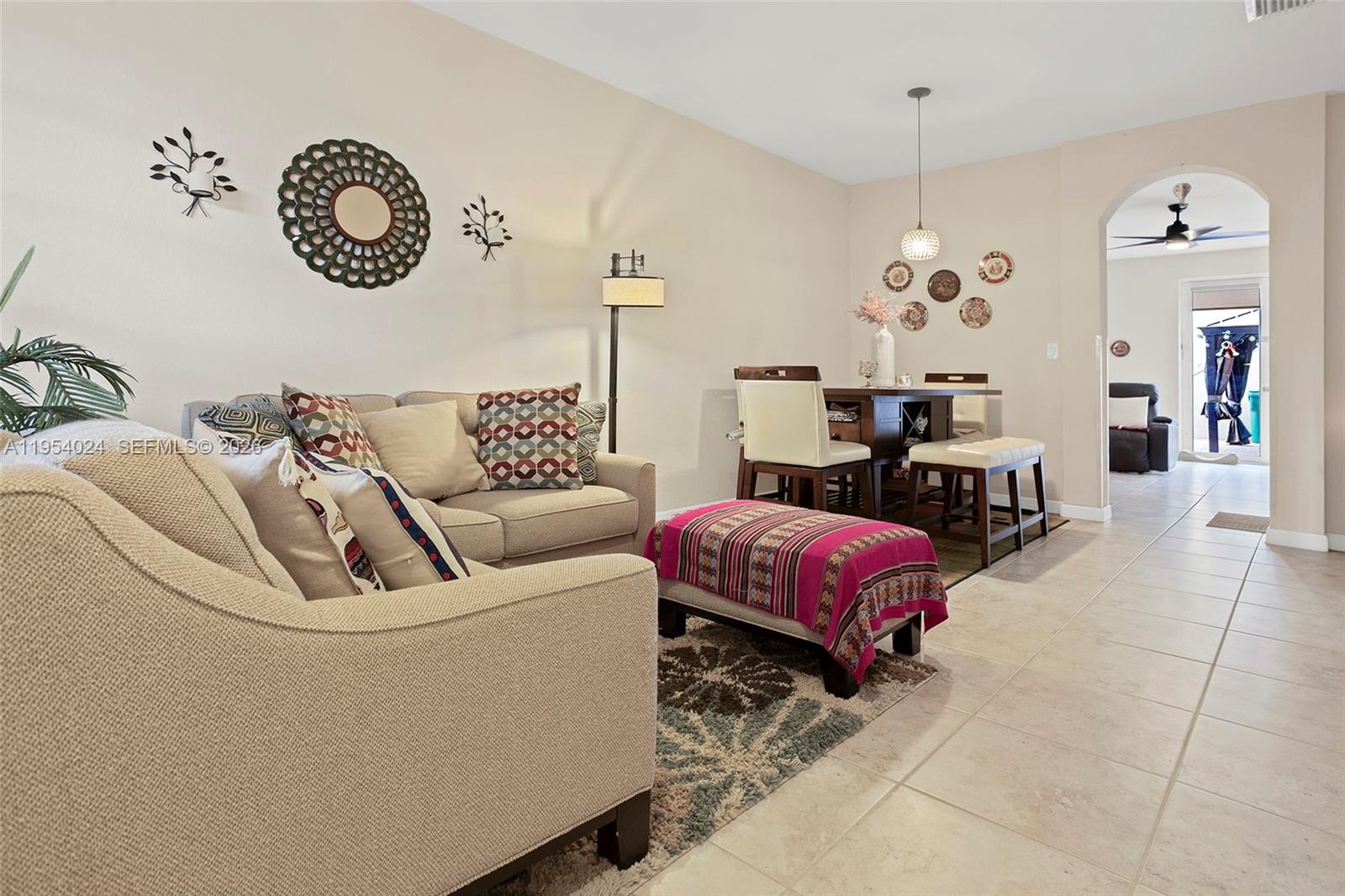 17149 Southwest 94th Street Miami, FL 33196 - Photo 7 of 36 a living room with furniture and a chandelier