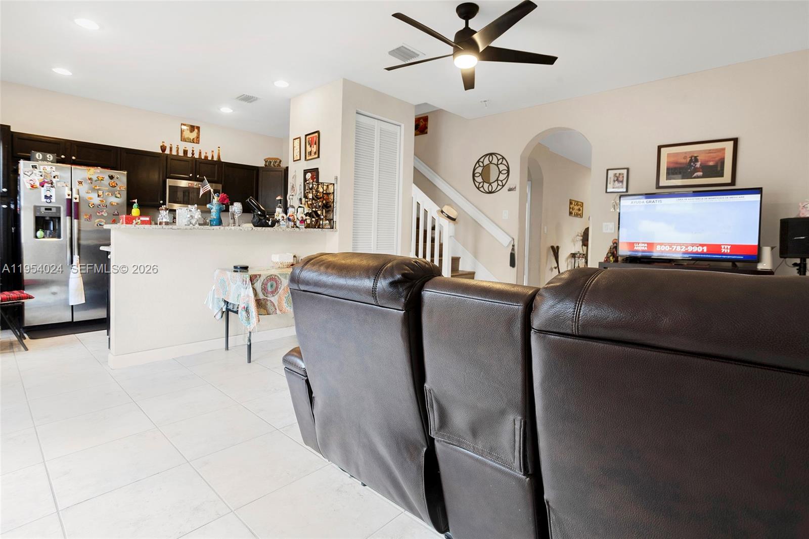 17149 Southwest 94th Street Miami, FL 33196 - Photo 9 of 36 a living room with furniture and a flat screen tv