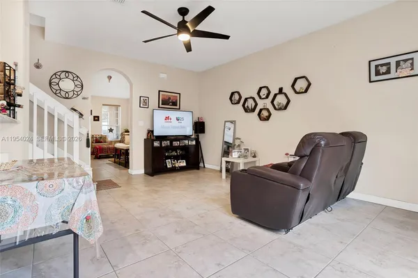 a living room with furniture and a flat screen tv