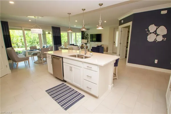 a large white kitchen with a large window