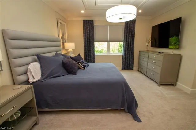 a bedroom with a bed and a flat screen television