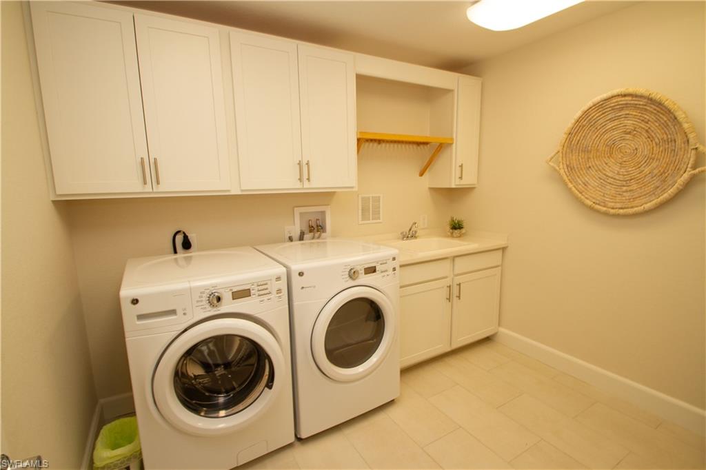 172 Indies Drive East, Unit 8102 Naples, FL 34114 - Photo 28 of 49 a utility room with dryer and washer