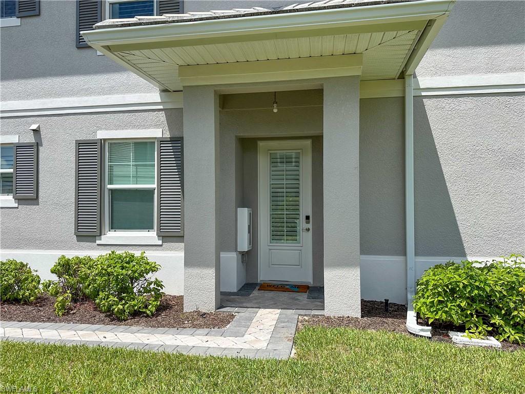 172 Indies Drive East, Unit 8102 Naples, FL 34114 - Photo 3 of 49 a front view of a house with garden