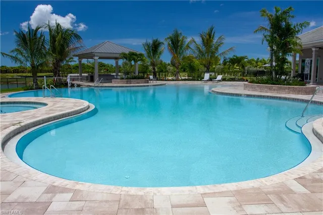 a view of a swimming pool with an outdoor space and seating area