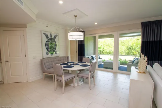 a dining room with furniture a chandelier and wooden floor