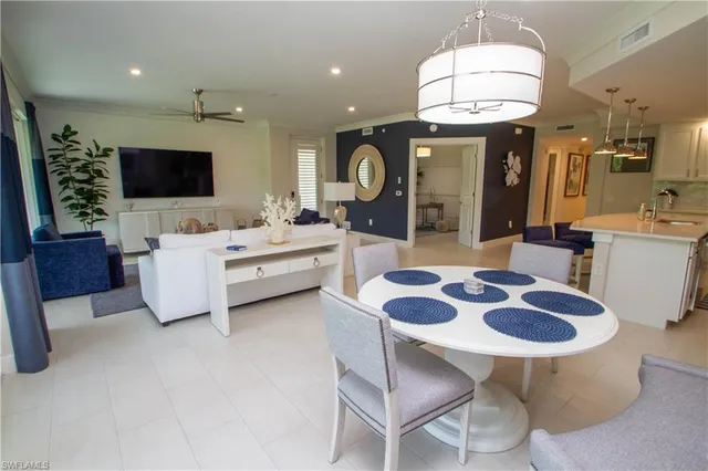 a large kitchen with a table and chairs