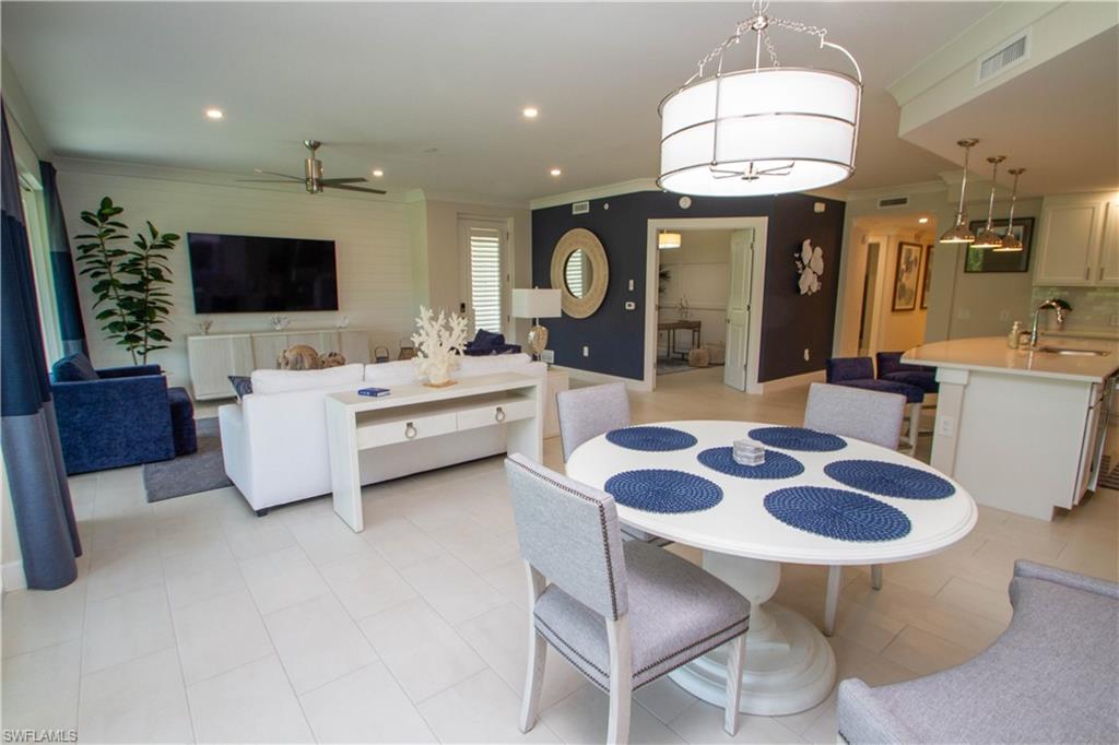 172 Indies Drive East, Unit 8102 Naples, FL 34114 - Photo 7 of 49 a large kitchen with a table and chairs