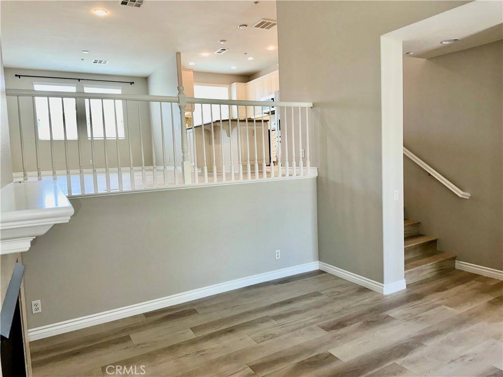 21 Durlston Way Ladera Ranch, CA 92694 - Photo 7 of 47 a view of a hallway with wooden floor and staircase