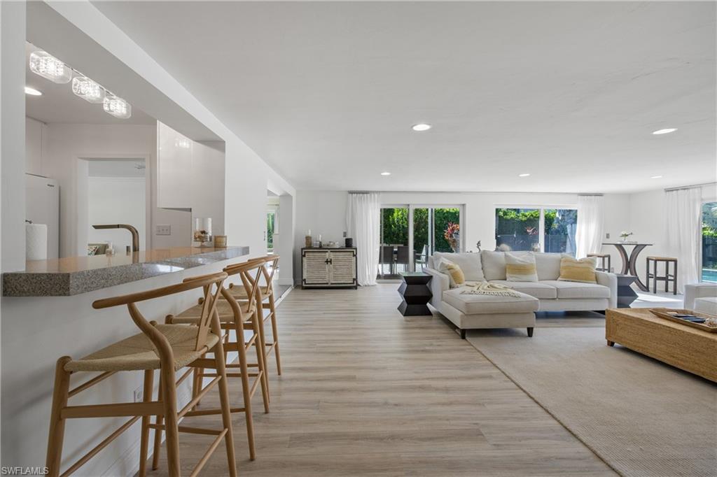 Living room with light wood-style floors and recessed lighting