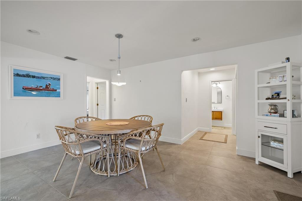 540 Rudder Road Naples, FL 34102 - Photo 19 of 37 Dining room featuring baseboards